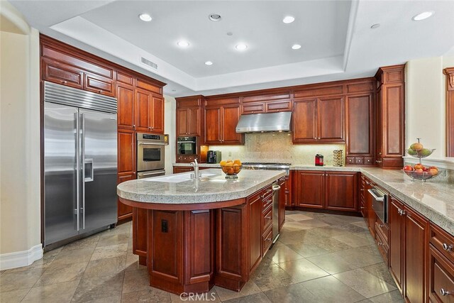 11755 Collar Ave, Tustin, CA 92782 - kitchen with stainless steel appliances, under cabinet range hood, a raised ceiling, a warming drawer, and recessed lighting