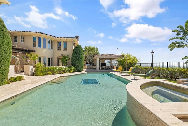 view of swimming pool with an in ground hot tub and a patio area