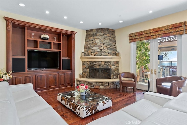 living room featuring french doors, dark hardwood / wood-style floors, and a fireplace