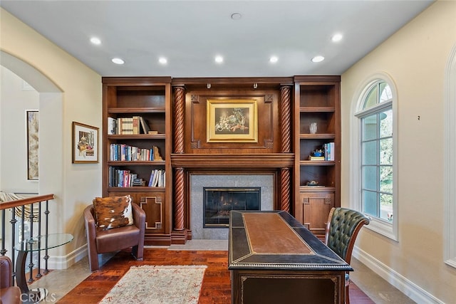 home office featuring a healthy amount of sunlight and dark hardwood / wood-style floors