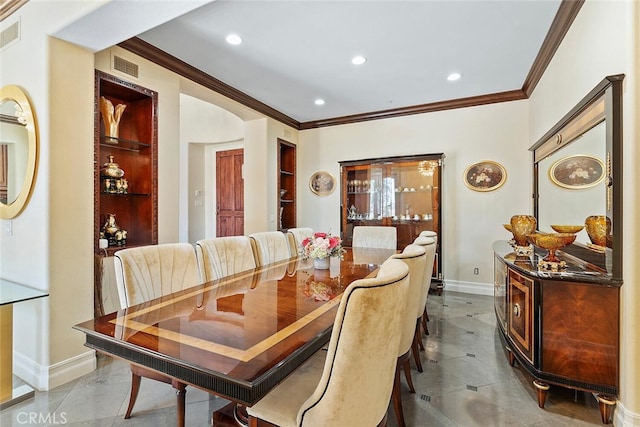 dining area with ornamental molding and built in features