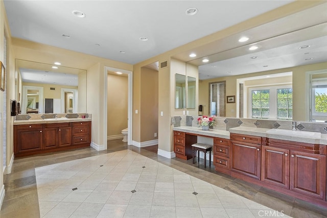 bathroom featuring backsplash, tile patterned flooring, vanity, and toilet