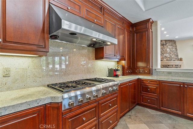 kitchen with exhaust hood, tasteful backsplash, and stainless steel gas cooktop