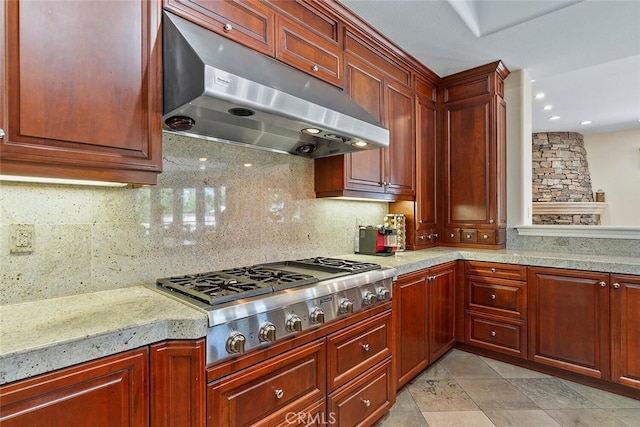 11755 Collar Ave, Tustin, CA 92782 - kitchen featuring under cabinet range hood, stainless steel gas stovetop, backsplash, dark brown cabinets, and light stone counters