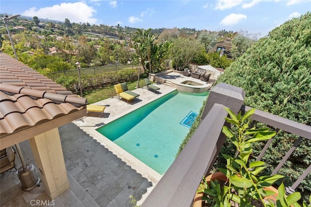 view of pool featuring a patio and an in ground hot tub