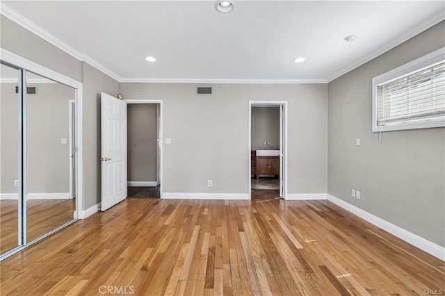 unfurnished bedroom with a closet, light hardwood / wood-style flooring, and ornamental molding