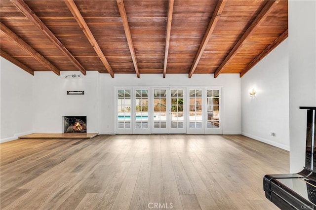 unfurnished living room with vaulted ceiling with beams, french doors, wooden ceiling, and hardwood / wood-style flooring