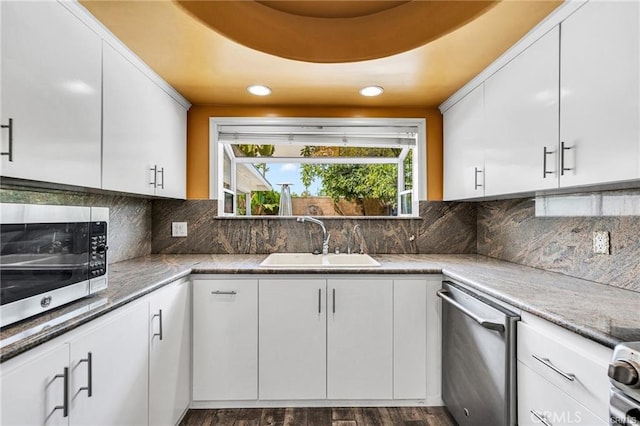 kitchen featuring dark wood-type flooring, white cabinets, appliances with stainless steel finishes, and sink