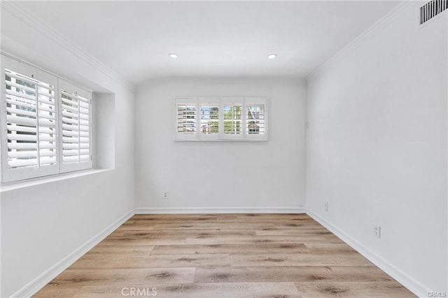 empty room with light hardwood / wood-style flooring and ornamental molding