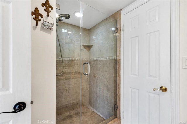 bathroom with a shower with door