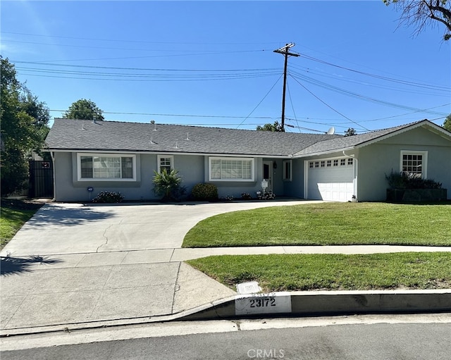 ranch-style house with a front yard and a garage