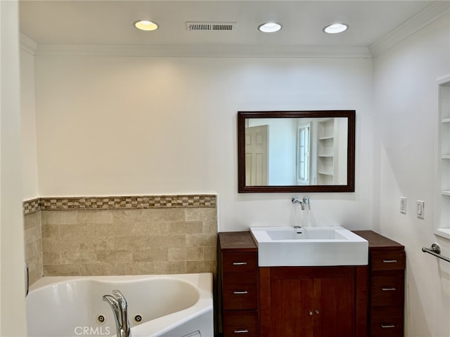 bathroom featuring crown molding, vanity, and a bathing tub