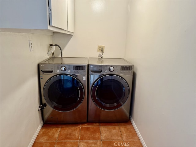 laundry area with cabinets, washing machine and dryer, and tile patterned floors