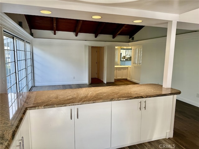 kitchen with white cabinetry, lofted ceiling with beams, dark hardwood / wood-style floors, and stone countertops