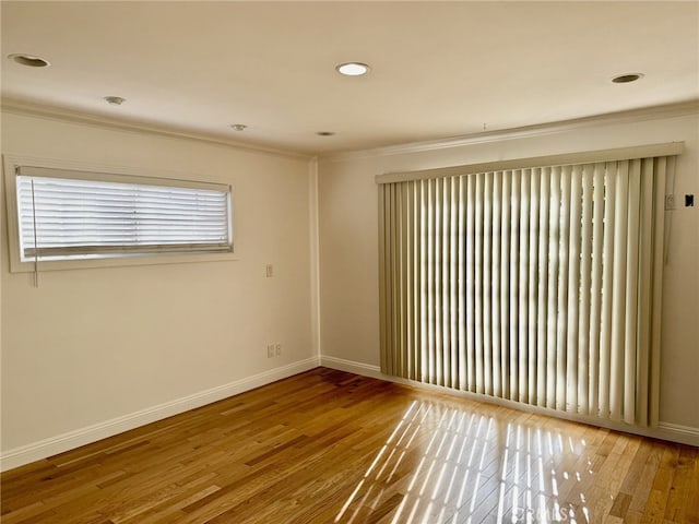 unfurnished room featuring crown molding and hardwood / wood-style floors