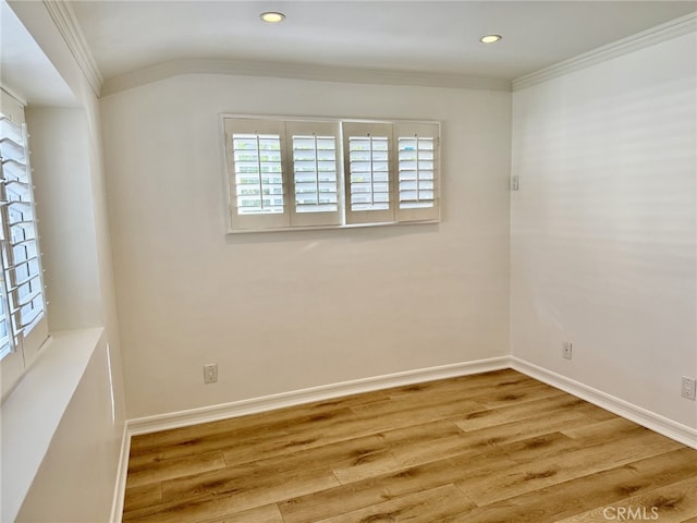 empty room with ornamental molding and hardwood / wood-style floors