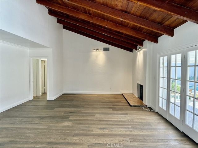 unfurnished living room featuring a fireplace, lofted ceiling with beams, hardwood / wood-style floors, and wooden ceiling