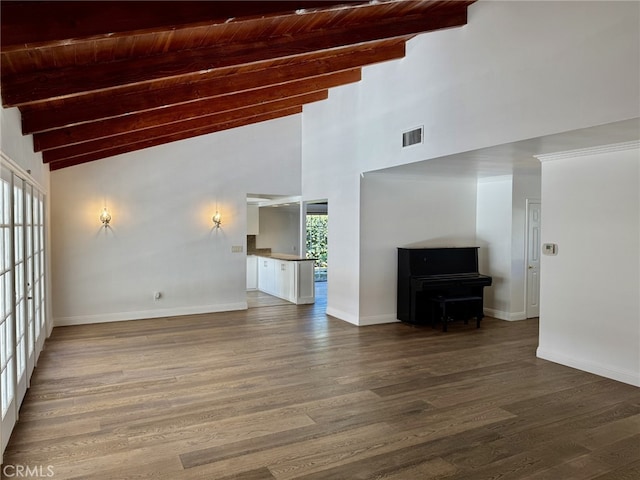 unfurnished living room featuring wood-type flooring, vaulted ceiling with beams, and wooden ceiling