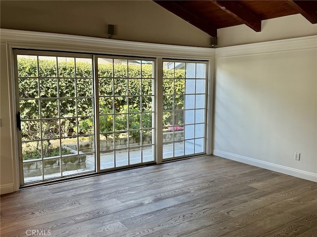 doorway featuring hardwood / wood-style flooring, vaulted ceiling with beams, and wood ceiling