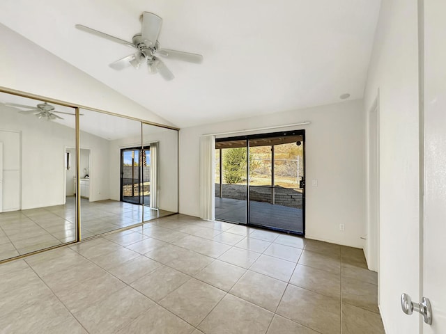 tiled spare room featuring ceiling fan and lofted ceiling