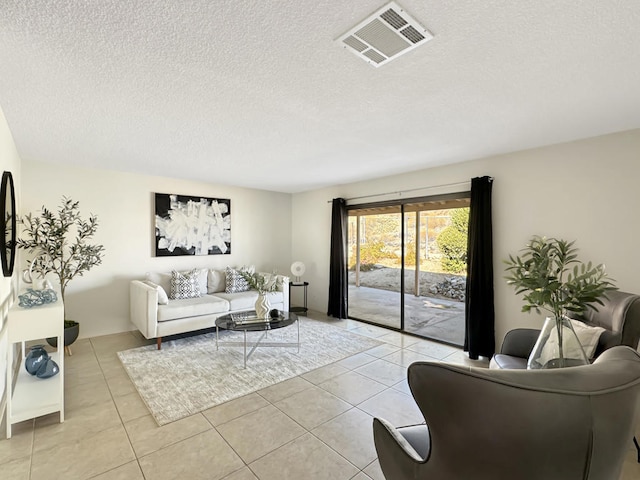 living room with light tile patterned floors and a textured ceiling