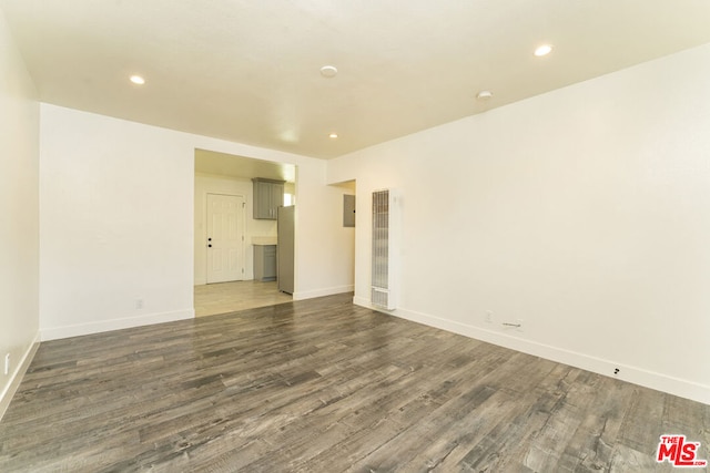 spare room with dark wood-type flooring