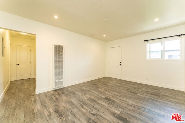 unfurnished room featuring dark hardwood / wood-style flooring