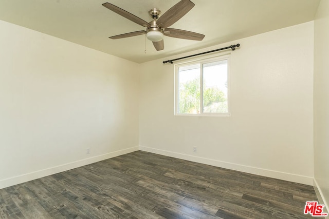 spare room with dark wood-type flooring and ceiling fan