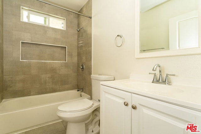 full bathroom with tiled shower / bath combo, vanity, toilet, and tile patterned floors