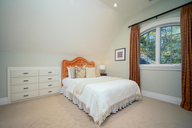 carpeted bedroom featuring lofted ceiling