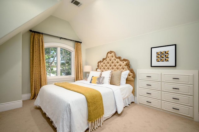 bedroom featuring light carpet and vaulted ceiling