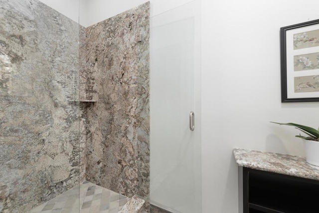 bathroom featuring vanity and an enclosed shower