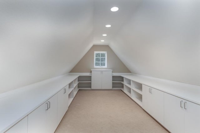 interior space featuring lofted ceiling and light colored carpet