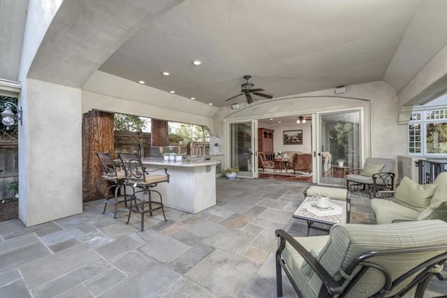 view of patio / terrace with exterior bar and ceiling fan