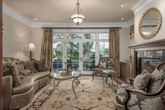 living room with french doors, a premium fireplace, ornamental molding, and hardwood / wood-style floors