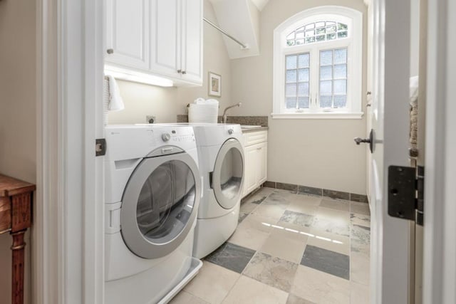 laundry area featuring cabinets, washer and dryer, and sink