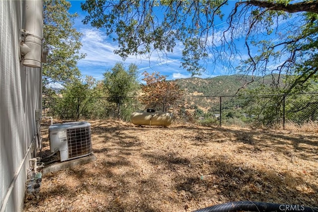 view of yard with cooling unit and a mountain view