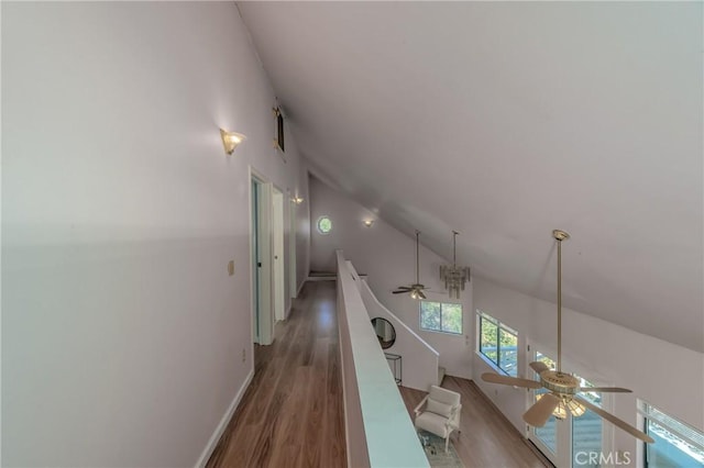 hallway featuring vaulted ceiling and hardwood / wood-style floors