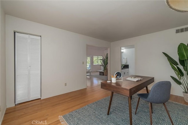 office space with light hardwood / wood-style flooring