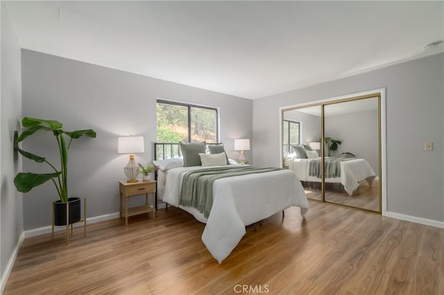 bedroom featuring light wood-type flooring and a closet