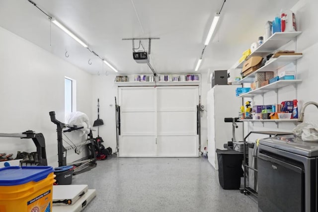 garage featuring washer / clothes dryer and a garage door opener