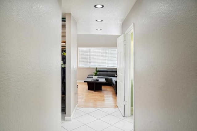 hall with light tile patterned floors