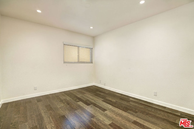 empty room with dark hardwood / wood-style floors