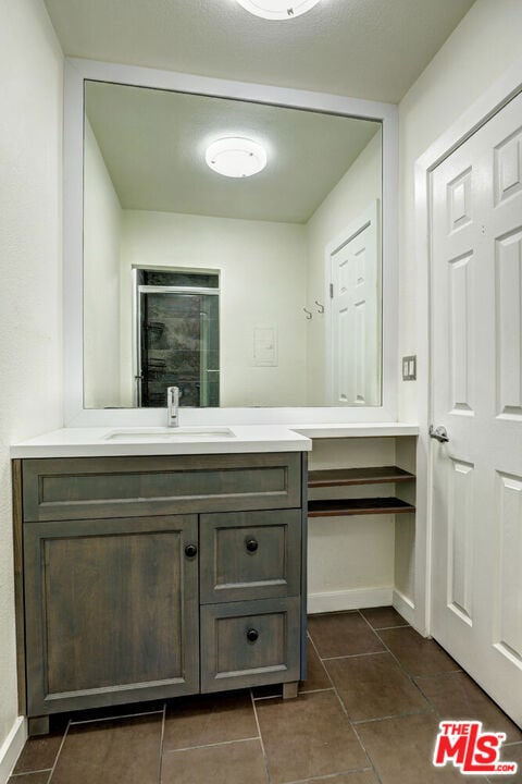 bathroom with tile patterned flooring and vanity