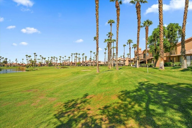 view of property's community featuring a water view and a yard