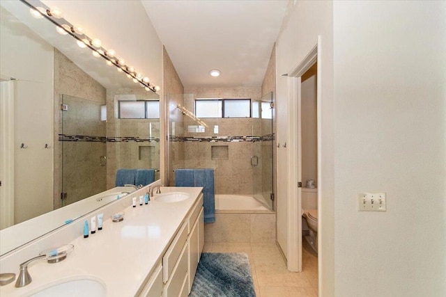 full bathroom featuring independent shower and bath, vanity, tile patterned flooring, and toilet