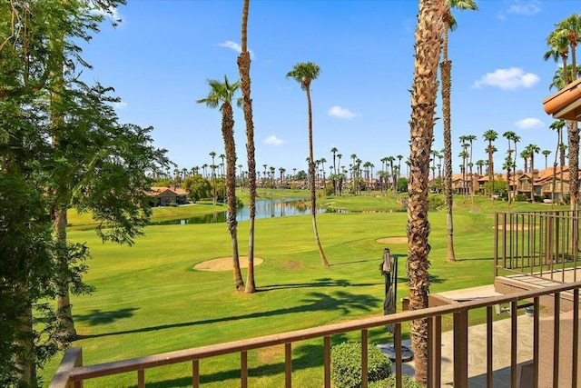 view of property's community with a yard and a water view