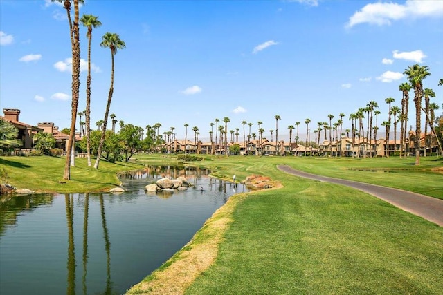 view of home's community with a lawn and a water view