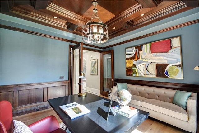 cinema room with beamed ceiling, light hardwood / wood-style flooring, ornamental molding, and a notable chandelier