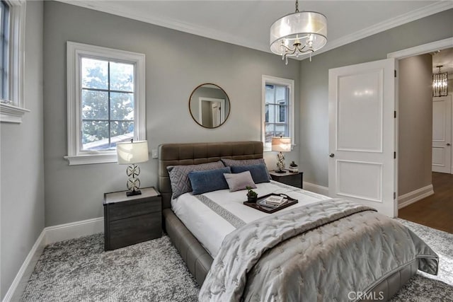 bedroom with hardwood / wood-style flooring, a notable chandelier, and crown molding